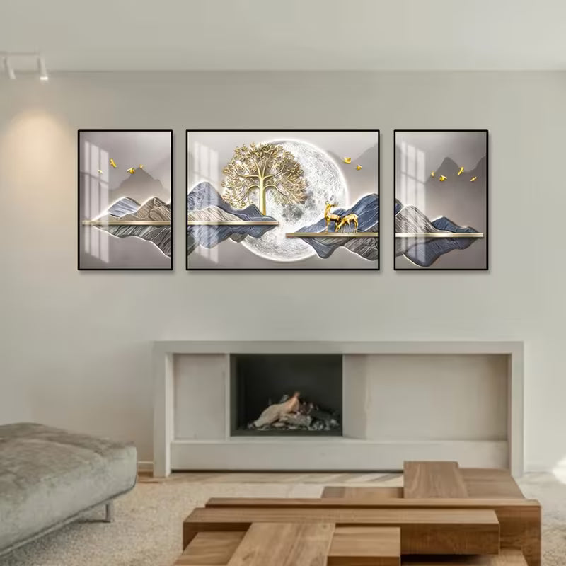 Modern living room with three framed artworks above a fireplace.