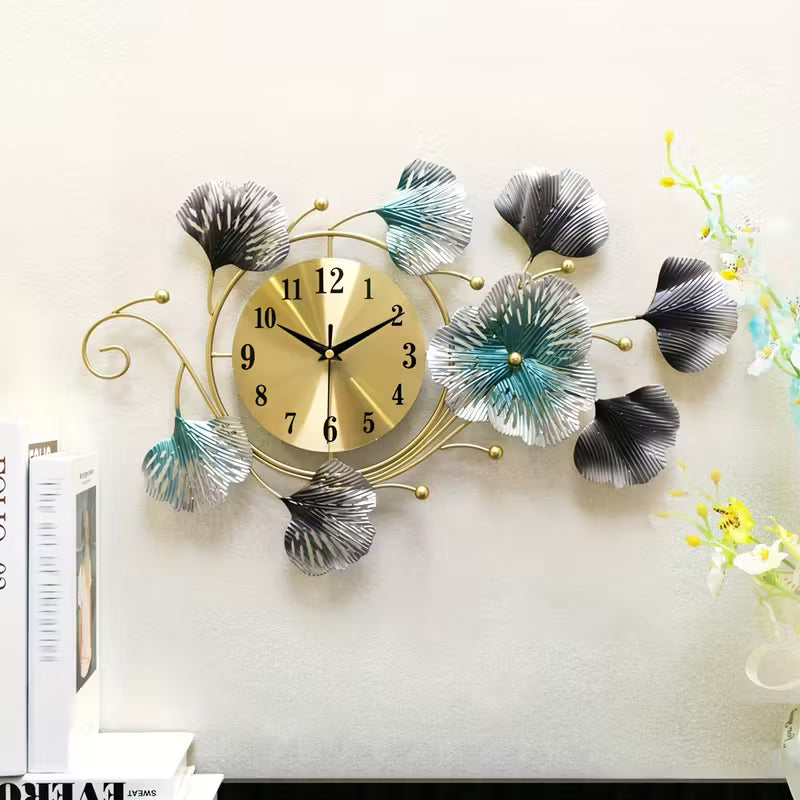 Decorative wall clock with leaf designs on a white wall