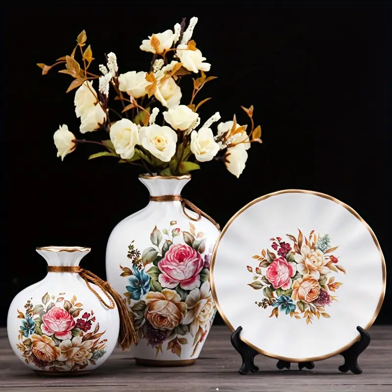 Set of decorative vases and a plate with floral designs on a dark background