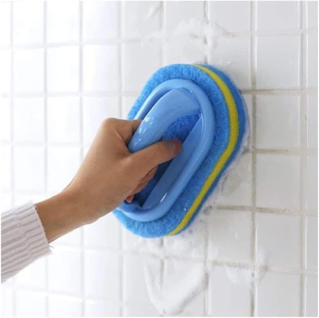 Hand using a blue scrubber with yellow handle on tiled wall