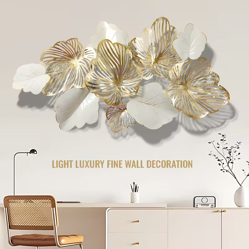 Decorative wall art with gold and white floral designs above a desk.