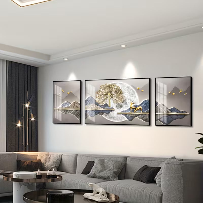 Modern living room with gray sofa and wall art featuring mountains and trees.