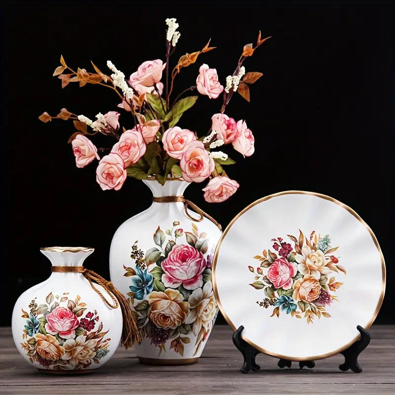 Set of decorative vases and a plate with floral designs on a dark background