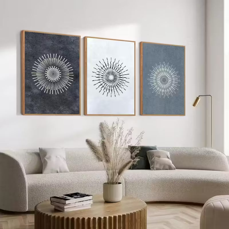 Modern living room with a white sofa, wooden coffee table, and abstract wall art.