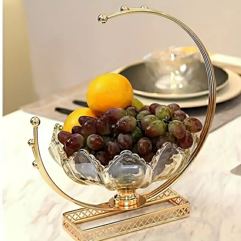 Decorative glass fruit bowl with gold rim on a marble surface
