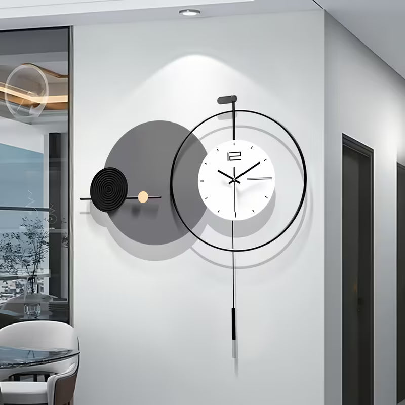 Modern wall clock with decorative design on a white wall in a room.