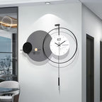 Modern wall clock with decorative design on a white wall in a room.