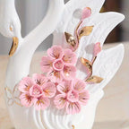 Decorative item with pink flowers and gold leaves on a white background