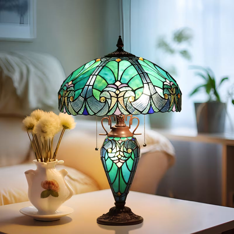 Decorative table lamp with stained glass shade on a surface, with a blurred background