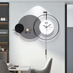 Modern wall clock with a minimalist design in a room with a table and chairs.