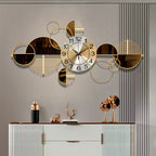 Decorative wall clock with geometric design on a gray wall above a white cabinet.