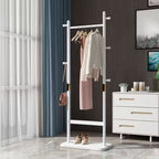 White freestanding coat rack with clothes in a room with a dresser and window.