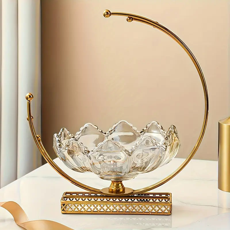Decorative glass bowl with gold metal frame on a white surface