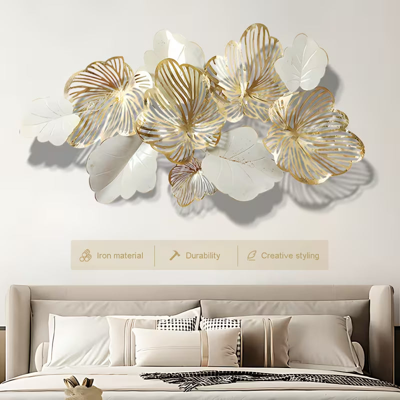 Decorative wall art with floral designs in gold and white above a sofa.