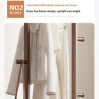 White jacket with pearl details on a mannequin against a neutral background