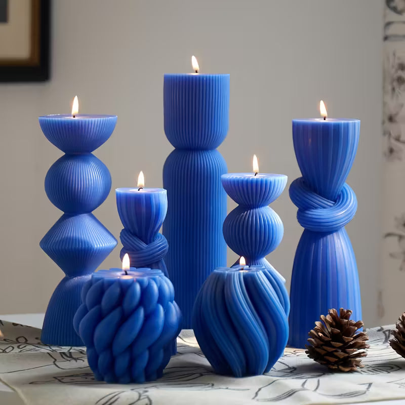 Set of blue candle holders with candles on a table
