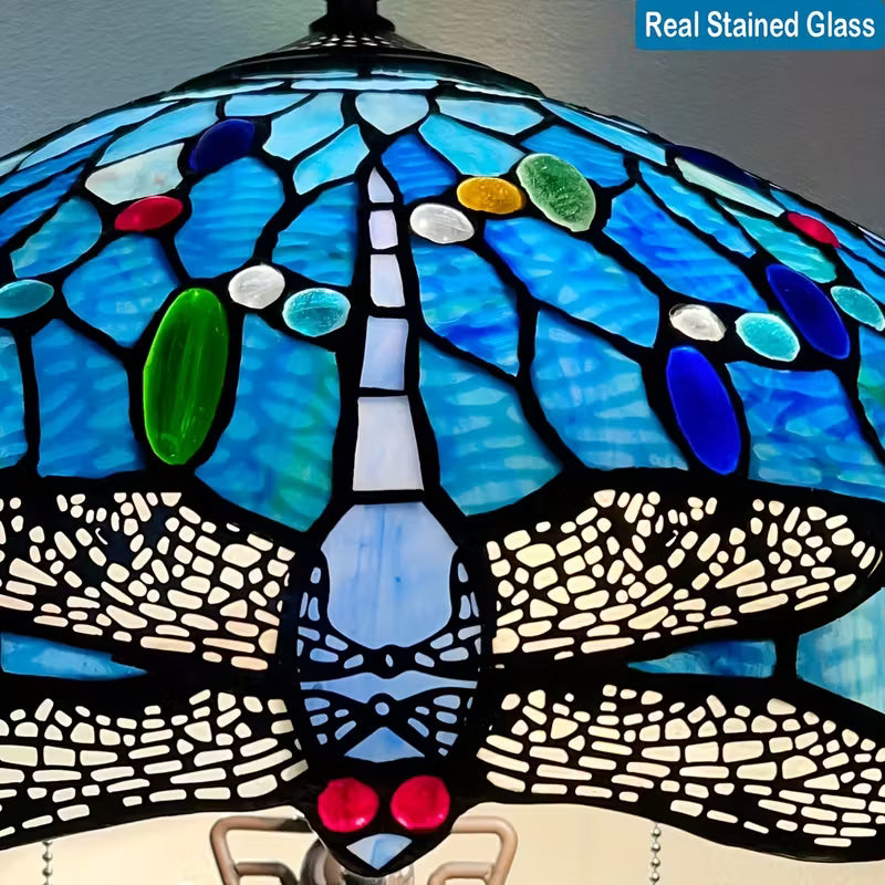 Stained glass lamp with blue, green, and red colors on a gray background