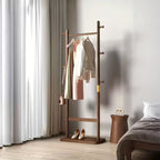 Wooden coat rack with clothes in a bedroom setting