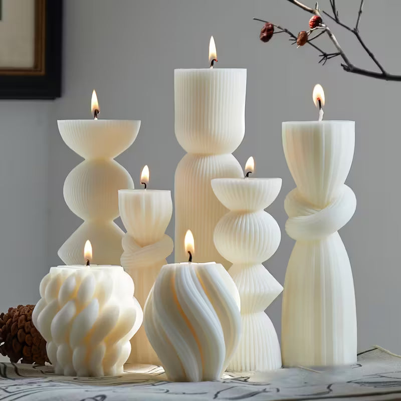 Set of decorative candles with unique designs on a surface.